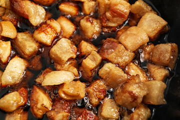 Tasty cracklings in frying pan