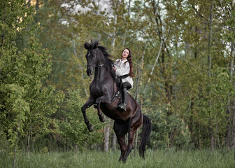 Beautiful long-haired girl riding a horse