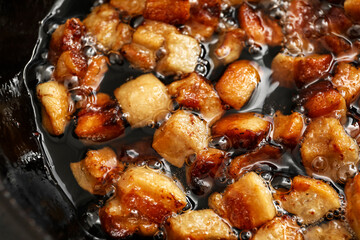 Tasty cracklings in frying pan