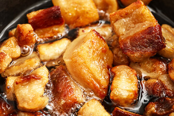 Tasty cracklings in frying pan