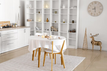 Dining table in light kitchen decorated for Christmas
