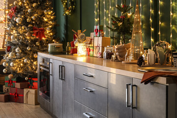 Grey counters with Christmas decor and glowing lights in kitchen