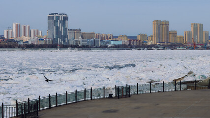 Ice drift. River Amur. View from the embankment of the city of Blagoveshchensk, Russia.