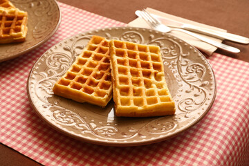 Plate of tasty Belgian Waffles on table in cafe