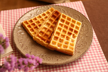Plate of tasty Belgian Waffles on table in cafe