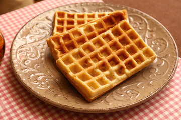 Plate of tasty Belgian Waffles on table in cafe