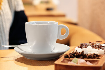Cup of hot tea on table in cafe