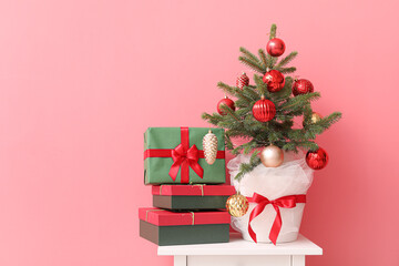 Christmas tree and different presents on color background