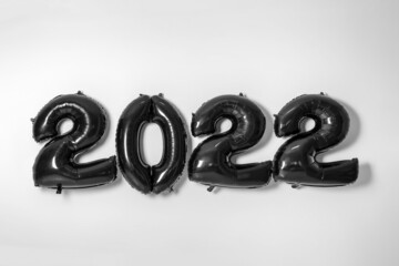Figure 2022 made of black balloons on light background