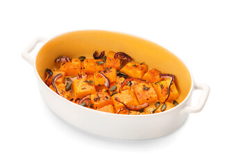 Dish with tasty baked pumpkin pieces on white background