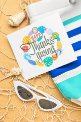 Fototapeta na wymiar Sunglasses, bag, seashells and paper card with text HAPPY THANKSGIVING on color background