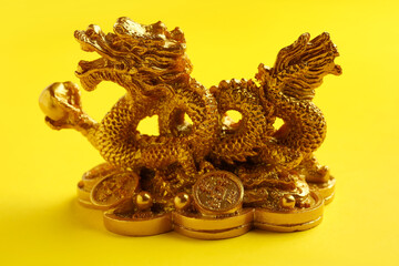 Figurine of Chinese dragon on color background