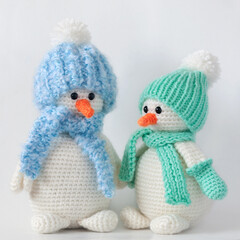 Handmade stuffed knitted toys – two snowmen on white background