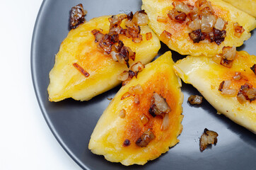 Close up of dumplings sprinkled with fried onion, traditional Polish, Russian and Ukrainian cuisine