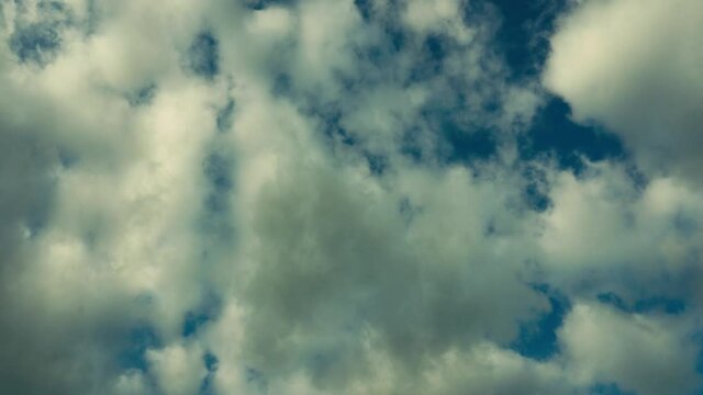 Background of bright blue sky and floating fluffy clouds. Dramatic sky.

