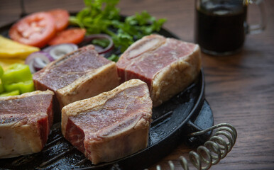 BEEF CUT INTO PIECES, WITH VEGETABLES SUCH AS TOMATO, ONION, PARSLEY, PEPPERS AND POTATOES, ON...