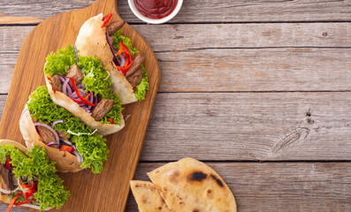 Pita with salad , paprika and beef meat