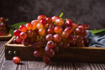 fresh ripe red seedless grapes  on wood table