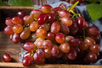 fresh ripe red seedless grapes  on wood table
