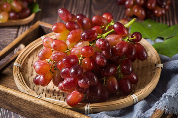 fresh ripe red seedless grapes  on wood table