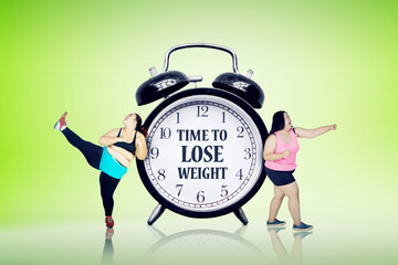 Two women exercise near text of time to lose weight