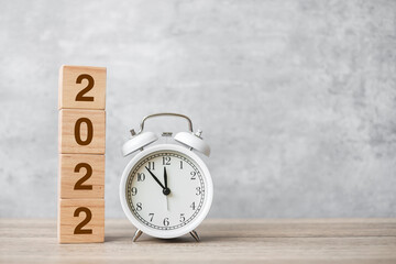 Happy New Year with vintage alarm clock and 2022 block. Christmas, New Start, Resolution, countdown, Goals, Plan, Action and Motivation Concept