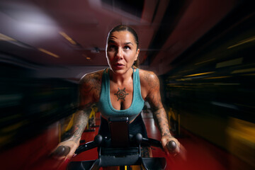 Fototapeta na wymiar zooming on woman in gym spin class