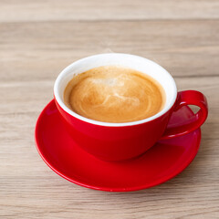 Obraz premium Hot espresso coffee on table, Red coffee cup in cafe or home.Top view with blank copy space for your text.