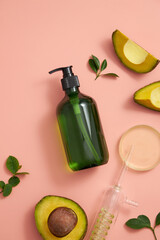 Avocado extract in test tube and petri dish with green leaf , cosmetic jar template for advertising pink pastel background , top view , photography experiment concept