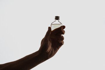 Alcohol bottle. Man hand alcohol. Bottle. Background. Photo. Shadow. Angry. 
