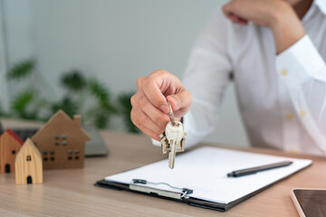 selling home. House sales agents send home keys to customers. The merchant closes the deal successfully after the customer agrees to sign the contract.