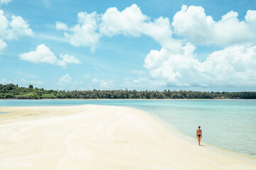 Beach travel - woman walking on sandy beach