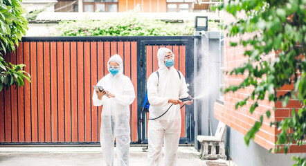 Professional teams for disinfection worker in protective mask and white suit disinfectant spray cleaning virus for help service kill coronavirus at customer home