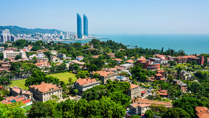 Fototapeta na wymiar Overlooking ancient buildings in Gulangyu, and modern buildings along the coast of Xiamen, China.