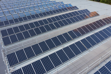 Obraz premium Drone fly over solar panel station in city at roof top building