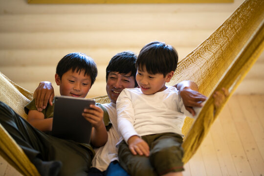 Father and Sons Relaxing in Hammock