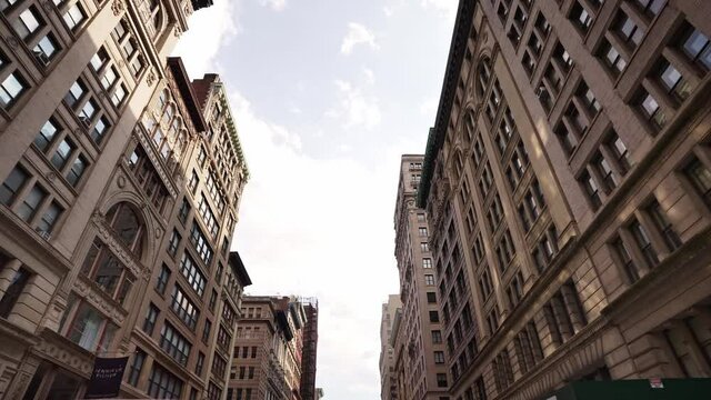 Looking up dolly shot of business skyscraper buildings in NYC. New York City is financial, economic and business center of America.