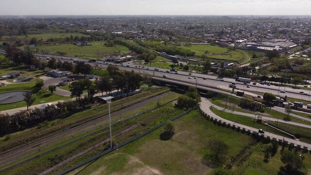 Ariel view of Pan America Highway(Panamericana) . AySa water purification plant on the right side and the city on the left side of the highway on a bright sunny day.