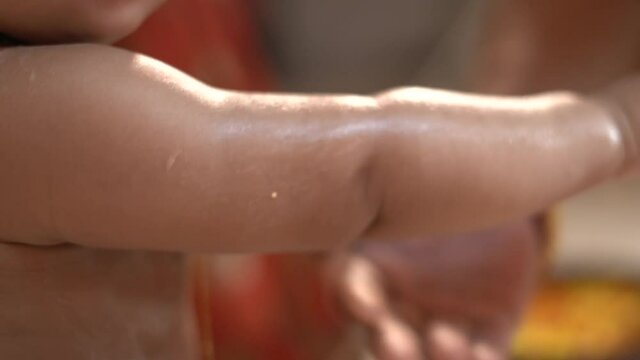 one 1 year old baby bath with milk an Chandan haldi mixture flowers royal bath by parents and grand parents