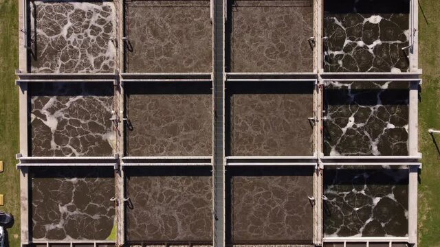 Top down view of AySA water purification plant in Buenos Aires Argentina where dirty water is collected in big square tanks for the purpose purification.