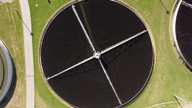 Descending Top down view of AySa water purification plant located in Buenos Aires containing circular pool where water is stored for purification purpose.