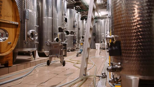 Massive stainless steel wine fermentation tanks in modern wine-cellar