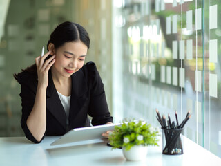 Female real estate agent reading the informations on tablet computer.