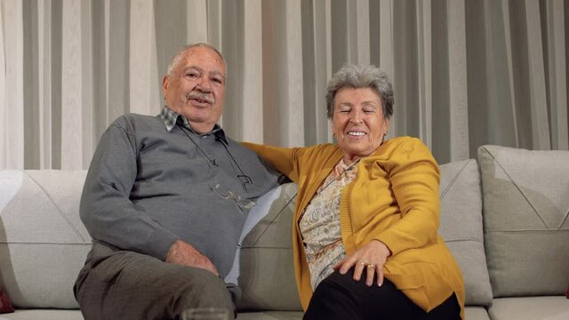 Elderly couple laughing at the camera.
A very happy family picture. The eyes of older men and women shine brightly.