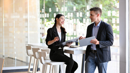 Business colleagues partner talking the new business project in modern meeting room.