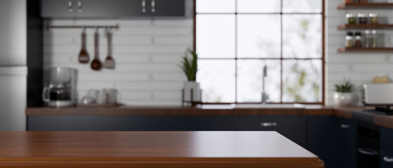 Vintage wooden kitchen island over a blurred contemporary vintage dark toned kitchen interior.