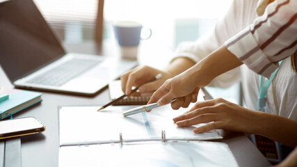 Cropped image of Two businesswomen discuss and voting business strategy plan