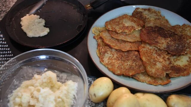 Frying of traditional Belarusian potato pancakes. Closeup of ingredients and fried draniki on plate