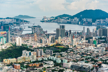 Panorama aerial view of Hong Kong Kowloon's crowded buildings and Victoria Harbour in China.