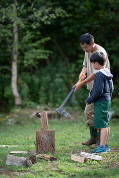 Father Teaches Wood Chopping to His Son